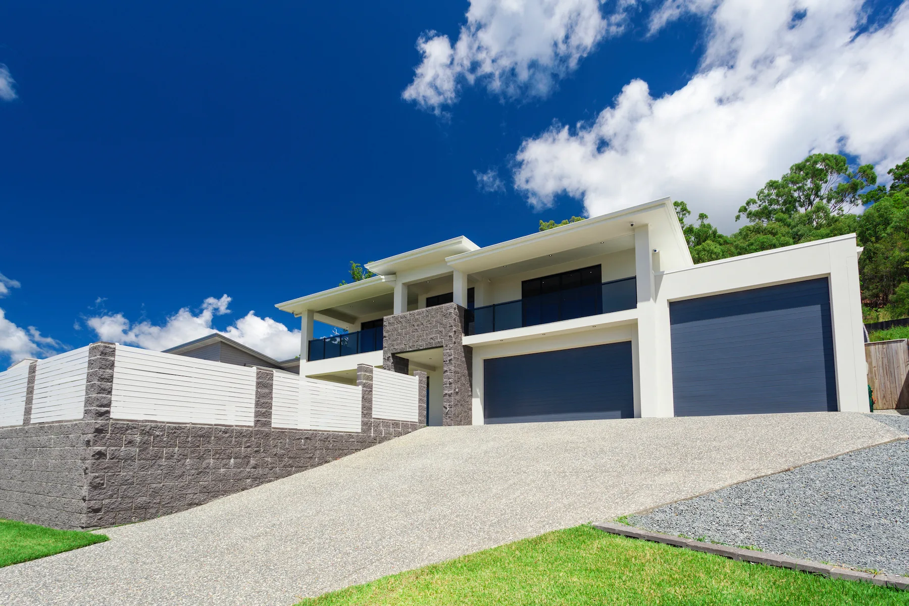 Freshly poured concrete driveway leading to a modern Pakenham home