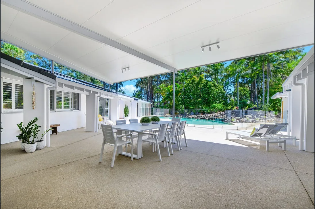 Concrete patio bordered by garden beds