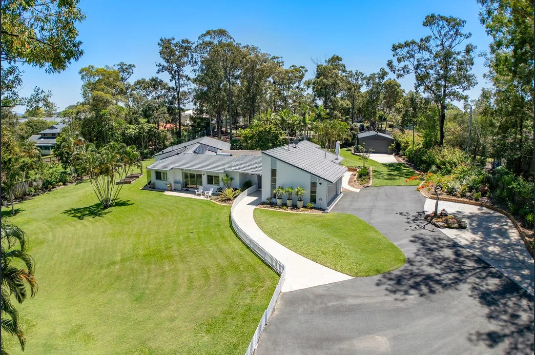 Aerial view of a concrete driveway on a large property